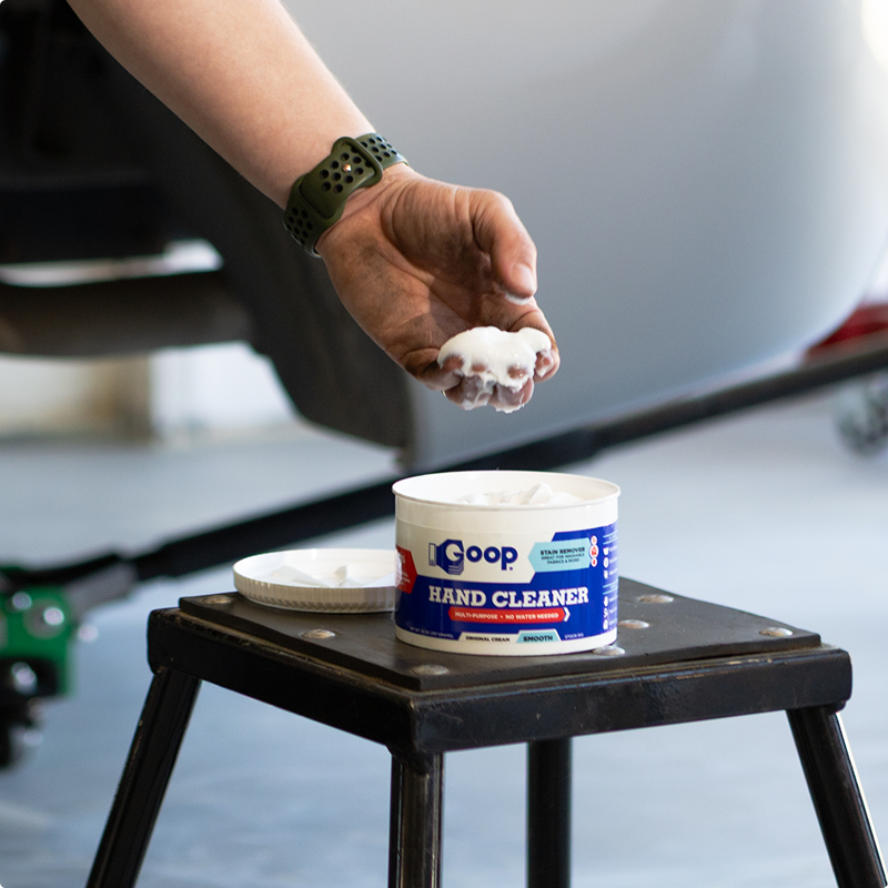 A person using the goop hand cleaner