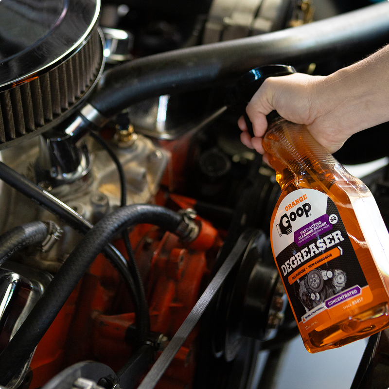 Orange goop degreaser being sprayed on engine parts